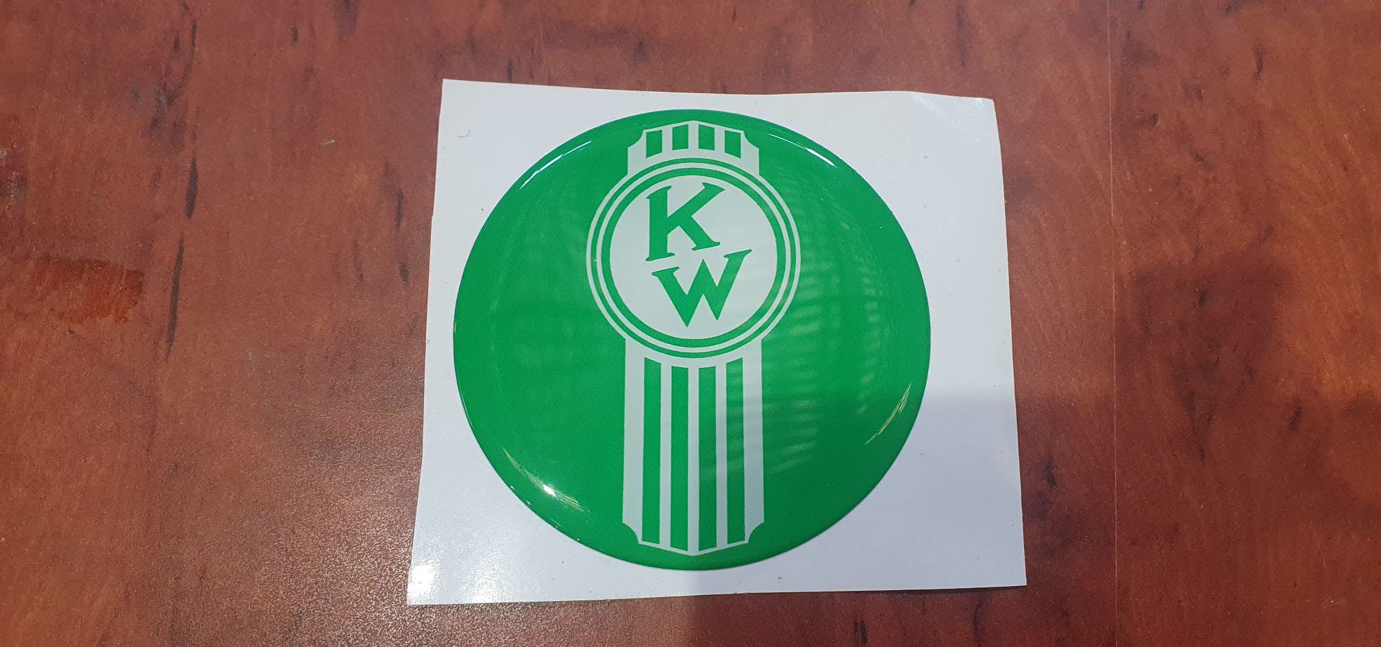 Round EPOXY DOMED DECALS 'Crooked white KENWORTH on a green background