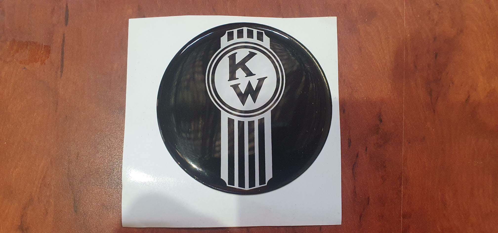 Round EPOXY DOMED DECALS 'Crooked white KENWORTH on a gloss black background