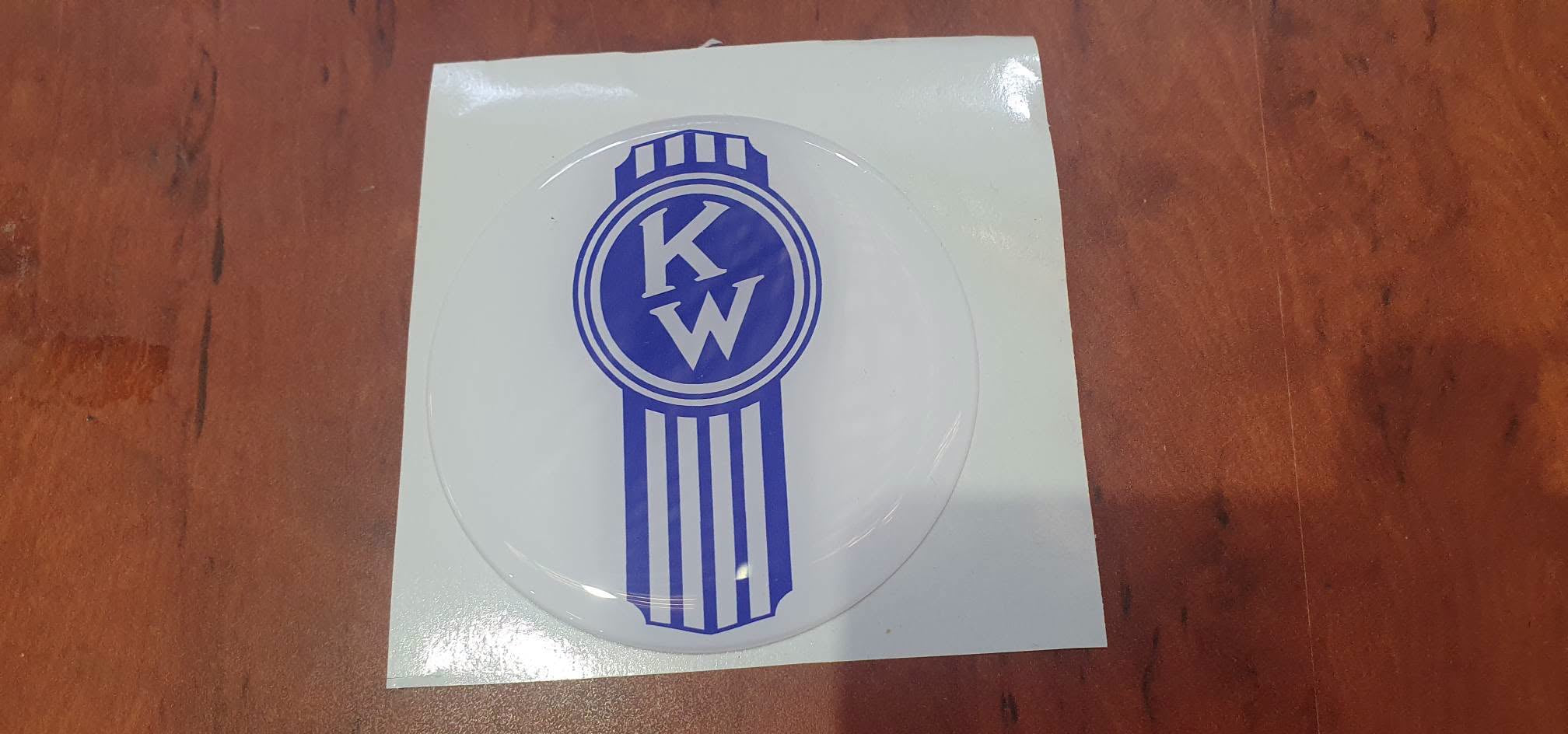 Round EPOXY DOMED DECAL 'Crooked' blue KENWORTH on a white background